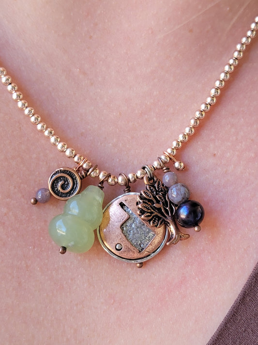 Necklace with various charms on a person's neck